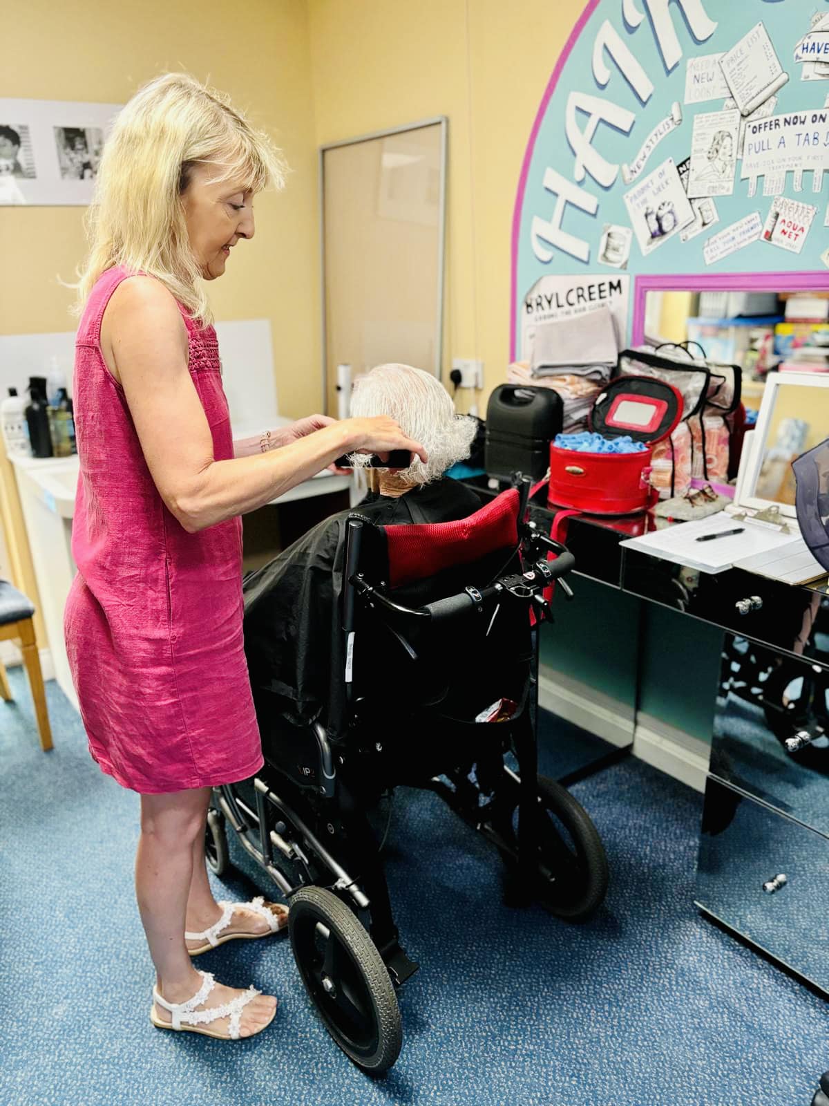 A member of staff helping in a resident's room