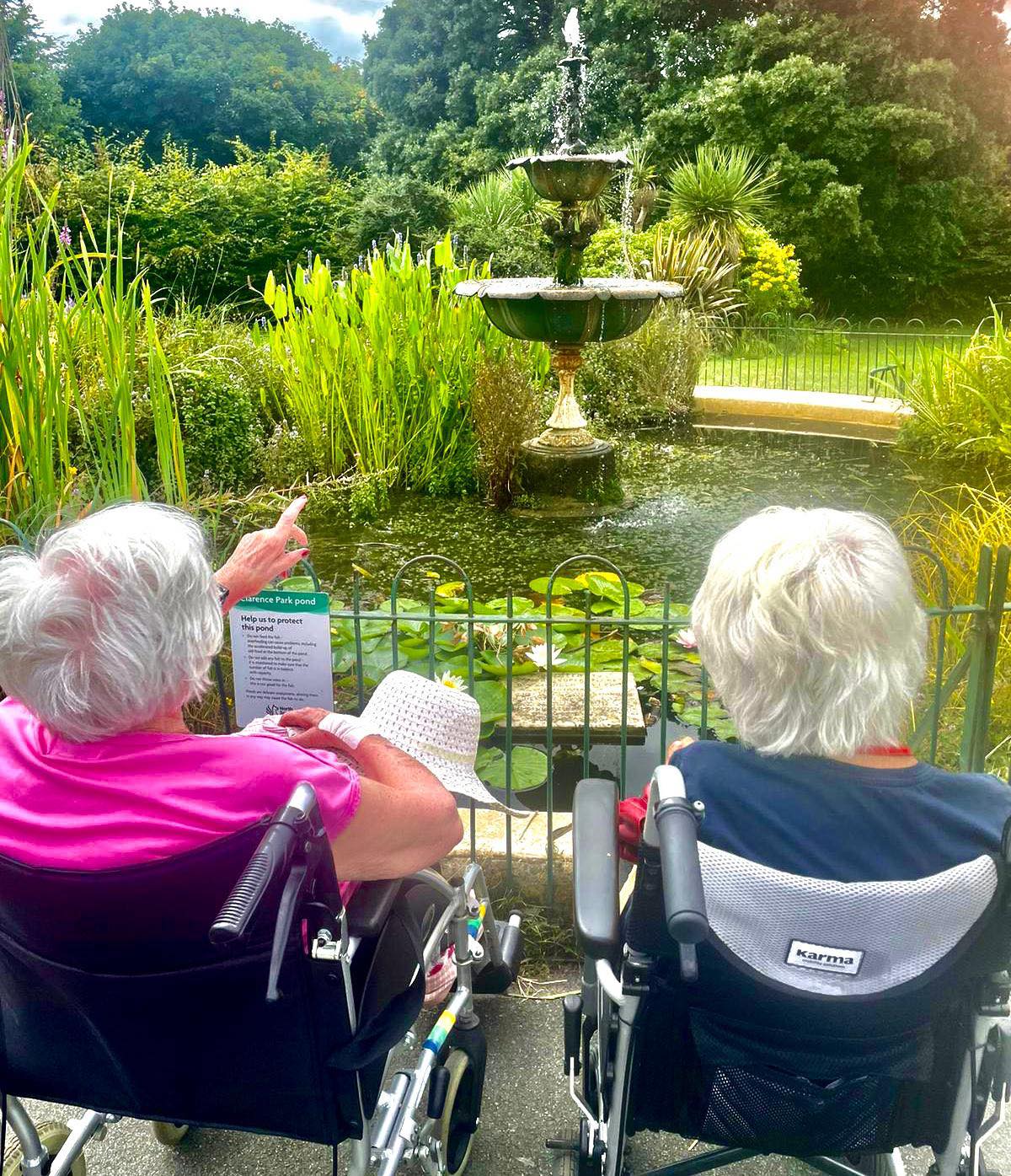 Residents relaxing beside the fountain in the courtyard garden
