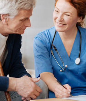 A nurse at Albert House chatting with a resident